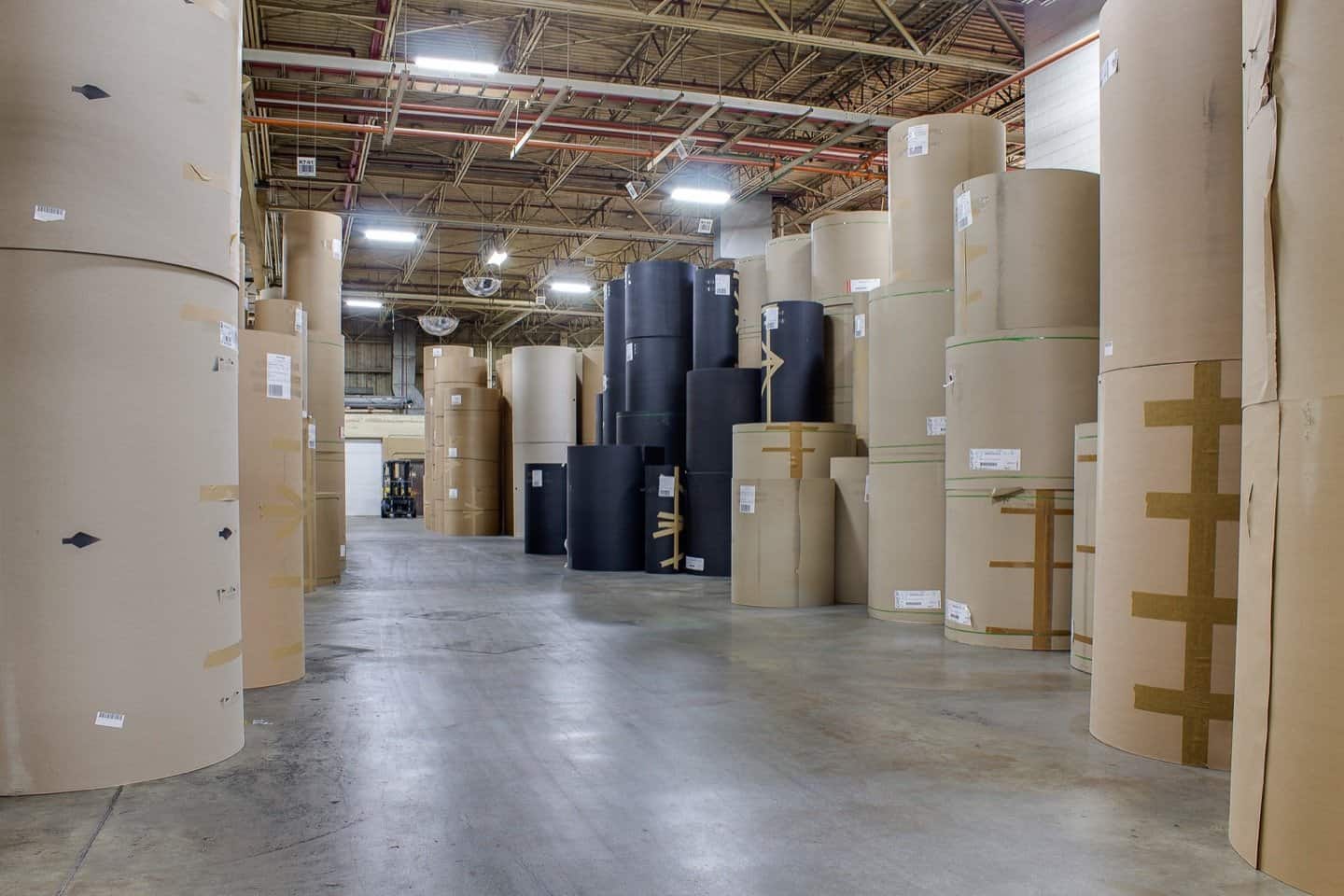 Rolls of kraft and coated paperboard stock held in the Constantine plant
